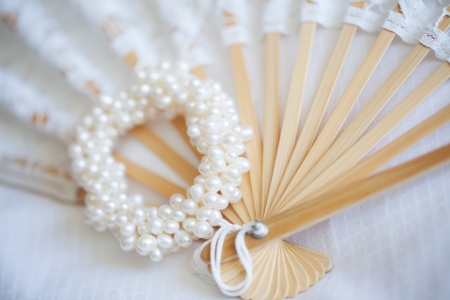 A hand fan and a beutiful pearl bracelet.の写真素材