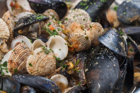 A bowl of mussels and other different shellfish.の写真素材