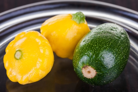Pattipans and baby marrows being photographed on a glass plate.の写真素材