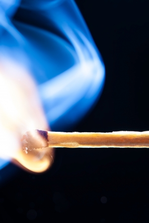 a match ablaze with smokeの写真素材
