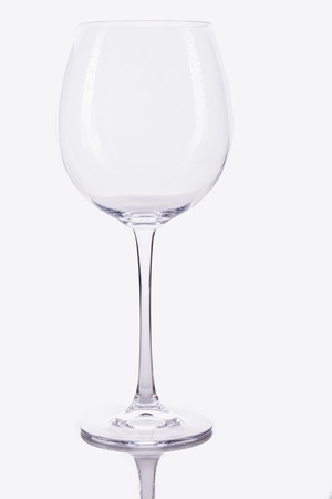 a studio caption of an empty whine glass with a reflection on a white backroundの写真素材
