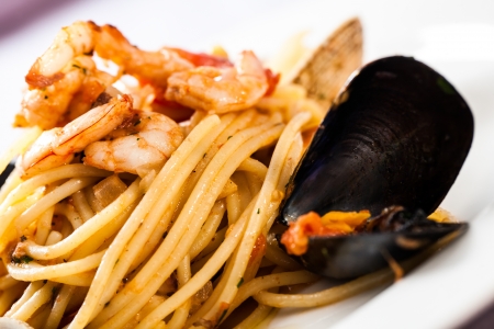 a detailed image of a freshly cooked seafood spaghetti with mussels and shrimpの写真素材