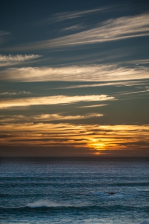 golden sunset over the restless oceanの写真素材