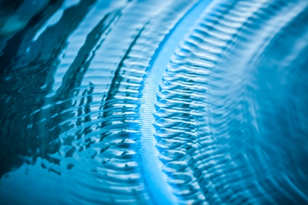 an abstract image of continues ripples in the still blue waterの写真素材