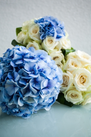 three bouquets with blue hydrangea flowers and white rosesの写真素材