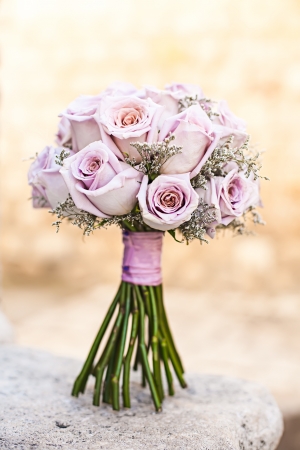 isolated purple wedding bouquet standing on a stone stepの写真素材