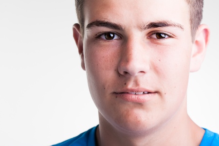 close-up of a young caucasian male models face with sparkly brown eyesの写真素材