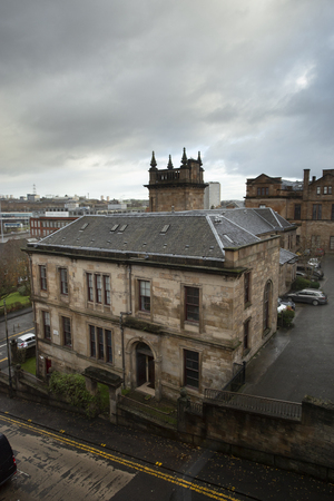 Typical English housing block underneath cloudy sky in Glasgow, Scotland.の写真素材