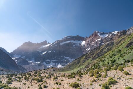 The beautiful mountain trekking road with clear blue sky and rocky hills in Fann mountains in Tajikistanの写真素材