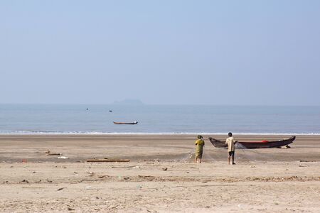 The two fishermen doing maintaining job for with net