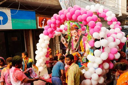 NEW DELHI, DELHI / INDIA â September 15 2016: Devotees are pulling a cart with an idol of Hindu god Ganesh on the occasion of Ganesh Visarjan, New Delhi, India.のeditorial素材