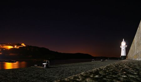 The lighthouse at Mevagissey harbour safely guides shipping into its safe havenの写真素材
