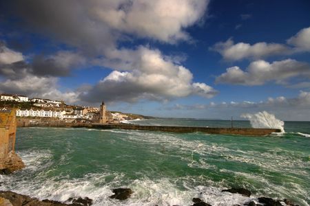 Porthleven harbour in West Cornwall is a very exposed to the prevailing weather conditions, so much so that there is an inner harbour to protect smaller vessels from the onslaught of the sea.の写真素材