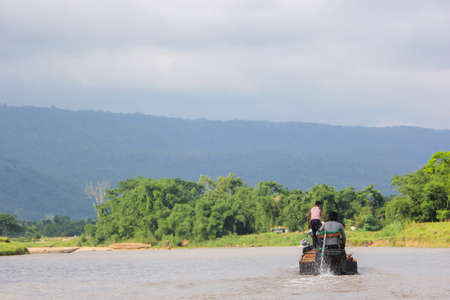 A wooden engine boat sailing through Tanguar Haor lake in sunamganj, Bangladeshの写真素材