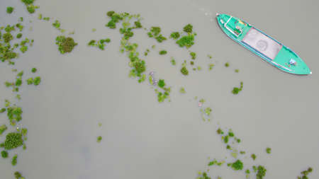 Aerial view of A paste color steel boat carrying sands on the Buriganga river in Dhaka, Bangladesh