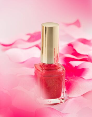Pink nail polish with rose petalsの写真素材