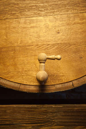 Big wood barrel with faucet in old wines cellarの写真素材