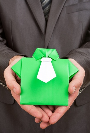 Businessman holding green origami suit in handsの写真素材