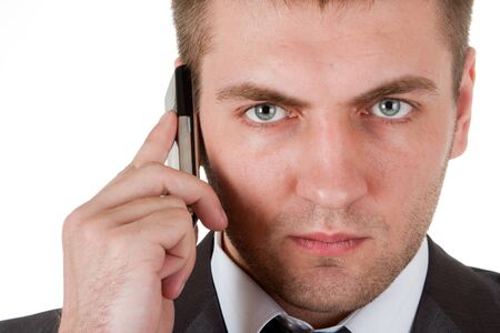 Portrait of serious businessman with phone. Isolated on whiteの写真素材