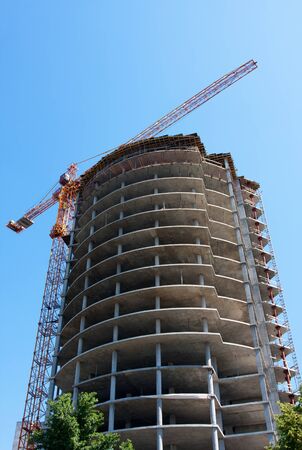 Construction of modern building against blue skyの写真素材