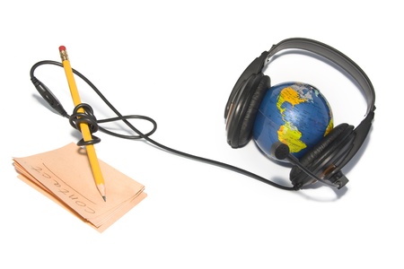 Headset on world globe with pencil and note isolatedの写真素材