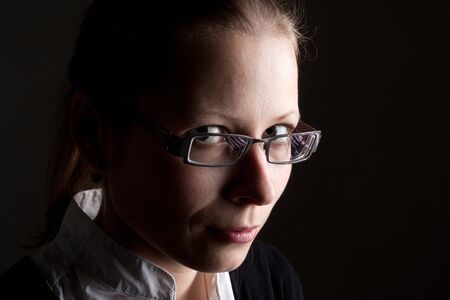 Portrait of beautiful pensive businesswoman in glassesの写真素材