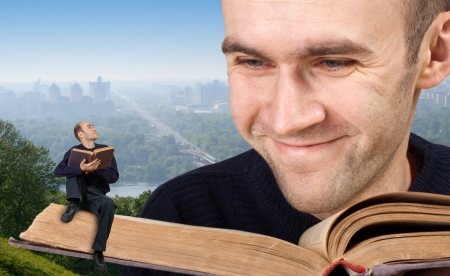Big and small men reading the bibleの写真素材