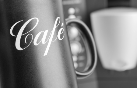 Close-up of cup with coffee machine on backgroundの写真素材