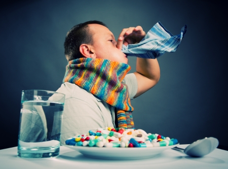 Ill man blowing his noseの写真素材
