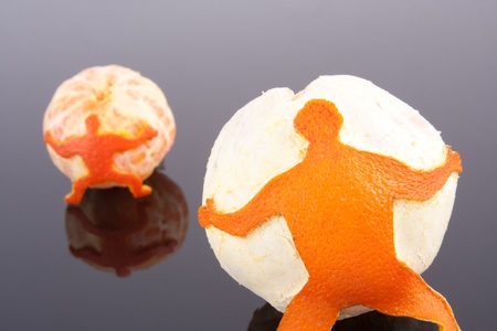 A strong men of peel holding big orange and mandarinの写真素材