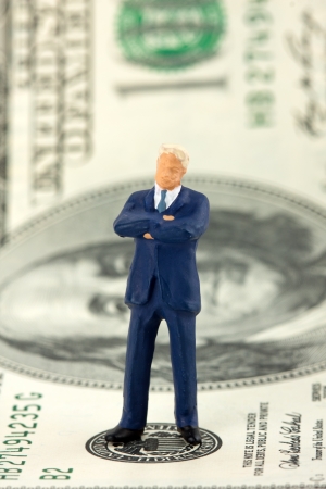 Miniature figurine of successful businessman on $100 banknoteの写真素材