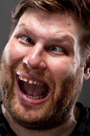 Portrait of crazy man making stupid face