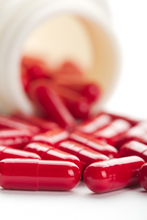 Pills spilling from an open bottleの写真素材
