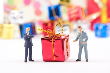 Miniature figurines of two businessmans with red Christmas giftの写真素材