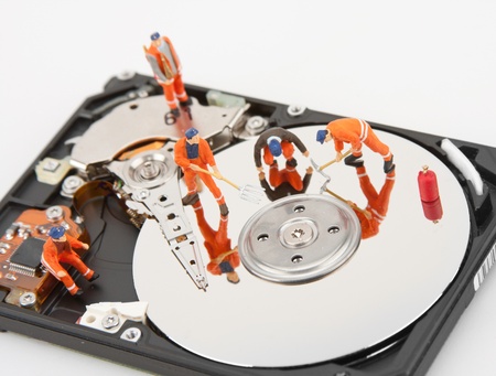 IT support. Workers repairing hard disk drive