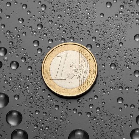 One EURO coin with water dropsの写真素材