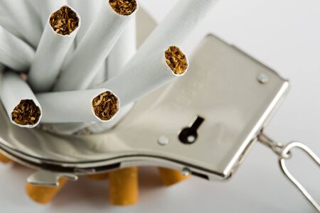 Heap of cigarettes locked to handcuffs. Closeup viewの写真素材