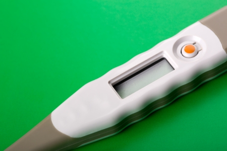 Closeup of digital thermometer on greenの写真素材