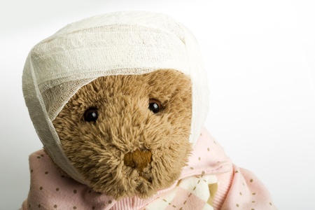 Portrait of teddy bear with bandage on the headの写真素材