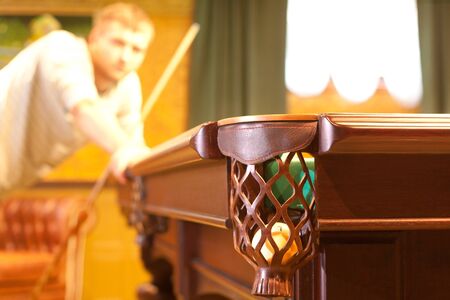 Billiard pocket with ball and player on background