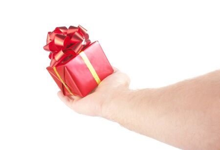 Small red gift in palm of hand. Isolated on whiteの写真素材
