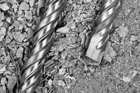 Industrial drills on cracked concrete. Close-up view