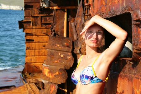 Bikini woman on abandoned ship looking at cameraの写真素材