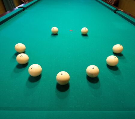 Smile shape billiard balls on green table