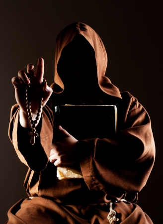 Portrait of mystery preaching monk with wooden rosary and bibleの写真素材