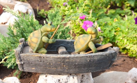 Garden statue. Two funny frogs on the boatの写真素材