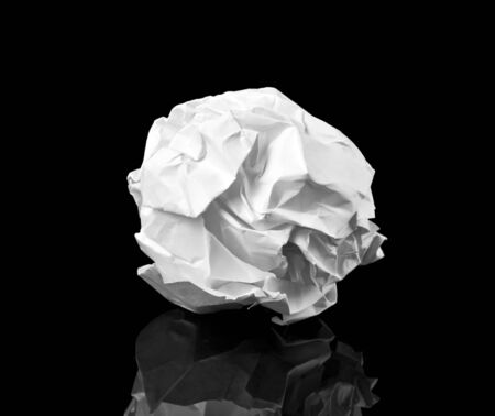 Crumpled paper ball on blackの写真素材