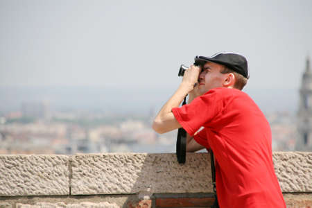 Tourist with camera photographing somethingの写真素材