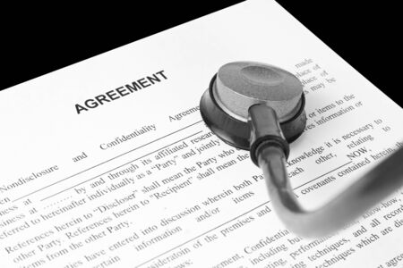 Examination of the business agreement. Isolated on blackの写真素材