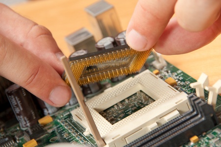 Installing computer processor to motherboardの写真素材